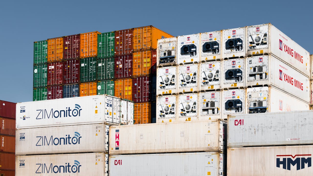 Colorful stacked shipping containers at Hamburg port, Germany, showcasing global trade logistics.